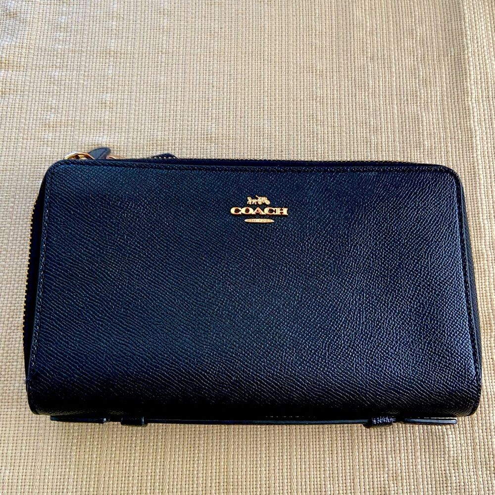 Coach wallet. Lots of space. Can fit a phone.